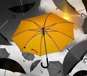 bright yellow umbrella among grey umbrellas by geralt at Pixabay
