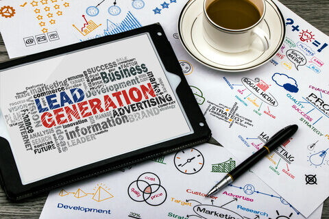 image of a desktop showing a tablet with Lead Generation on it, along side a cup of coffee