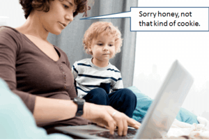 lady working on a laptop computer with child beside her. She is saying "Sorry honey, not that kind of cookie".